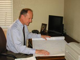 Jon reviewing project drawings at his desk
