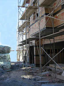 A multi-story building under construction with scaffolding